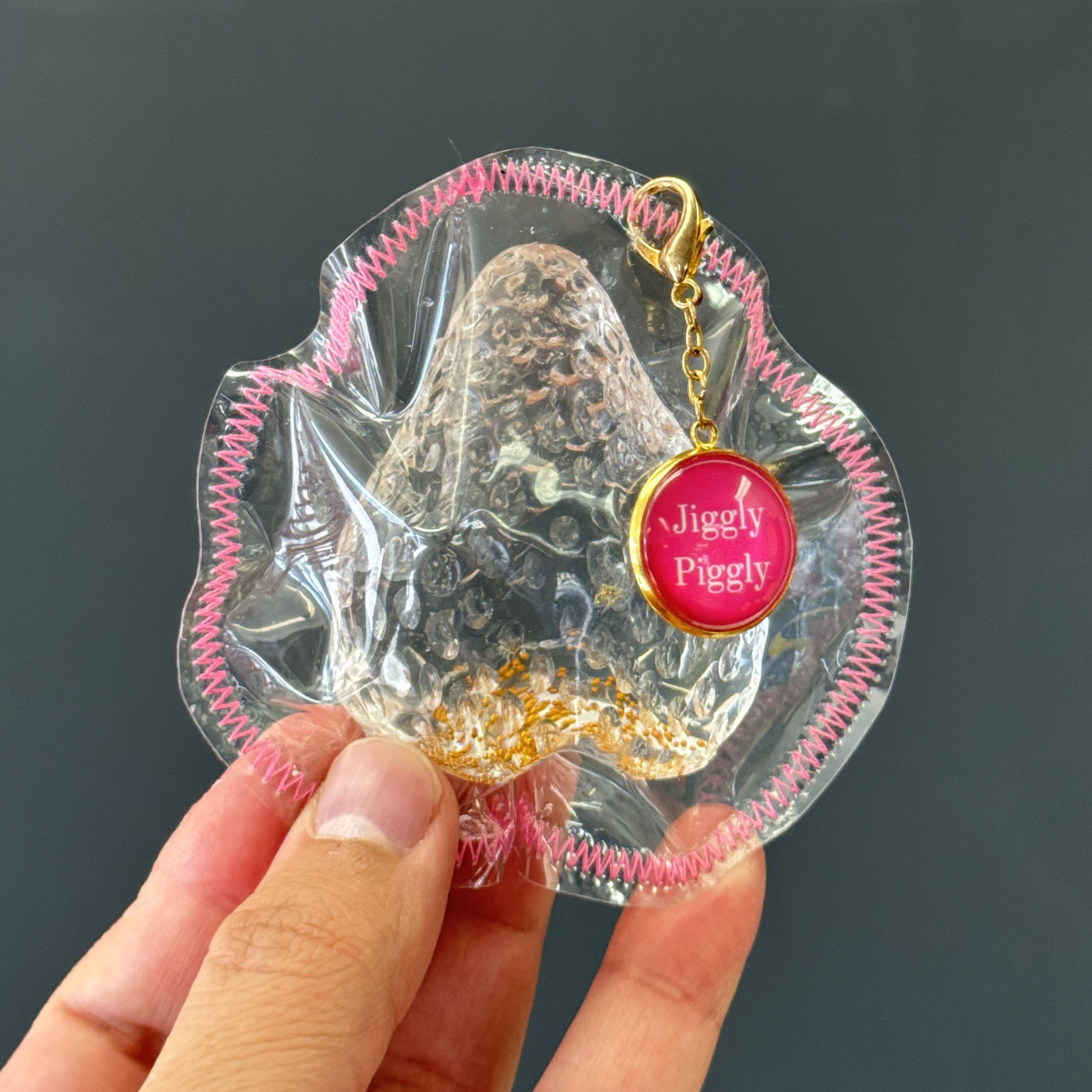 Handmade clear strawberry squishy toy with soft golden glow